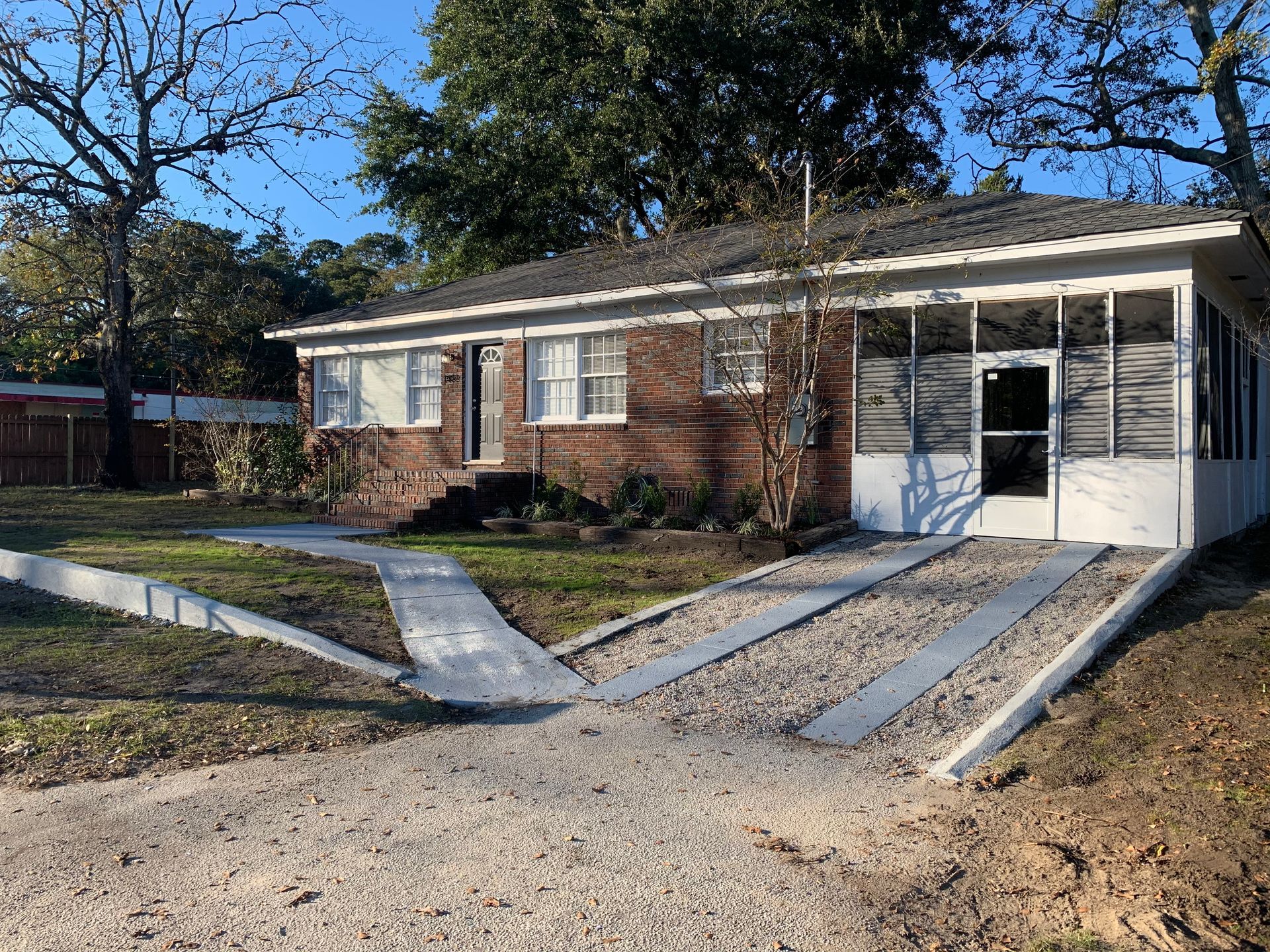 A brick house with a wheelchair ramp in front of it.