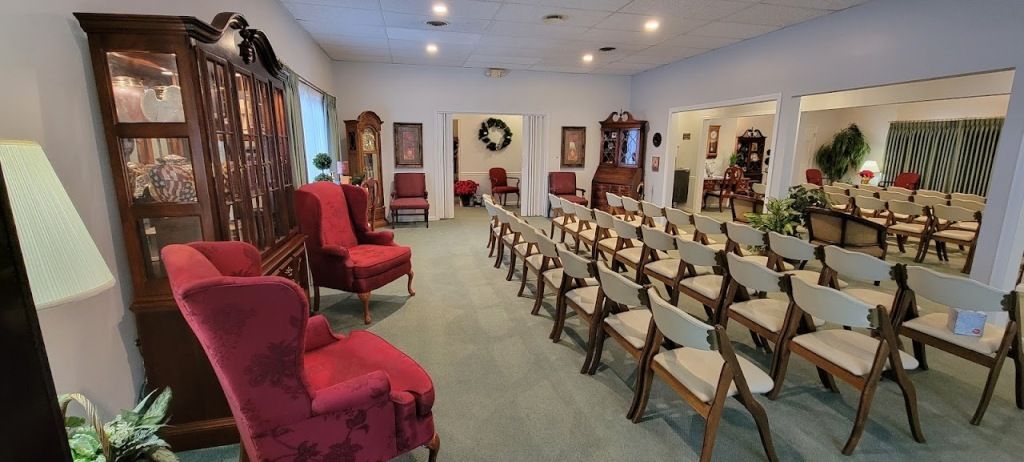 An interior view of a room, probably a waiting or event space, with rows of chairs.