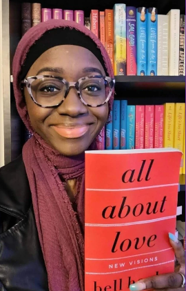 Person holding a book titled
