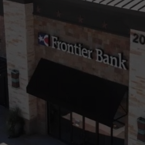 Frontier Bank storefront with a black awning and brick facade