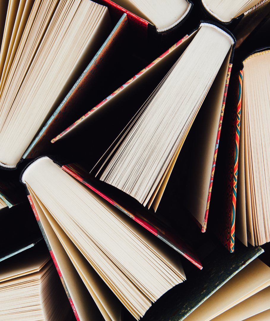 A bunch of books are stacked on top of each other