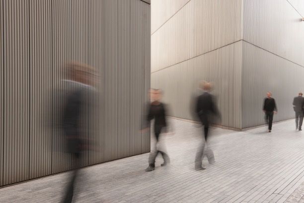 Four Newton's cradle steel balls striking one end ball against a gray background