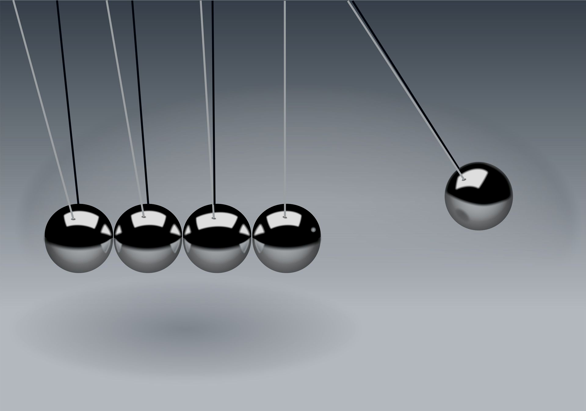 Four Newton's cradle steel balls striking one end ball against a gray background