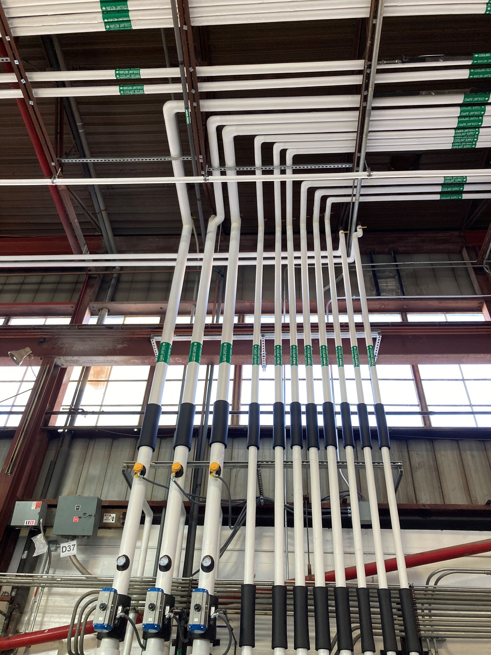 Pipes and valves in an industrial setting, above a utility sink, with 