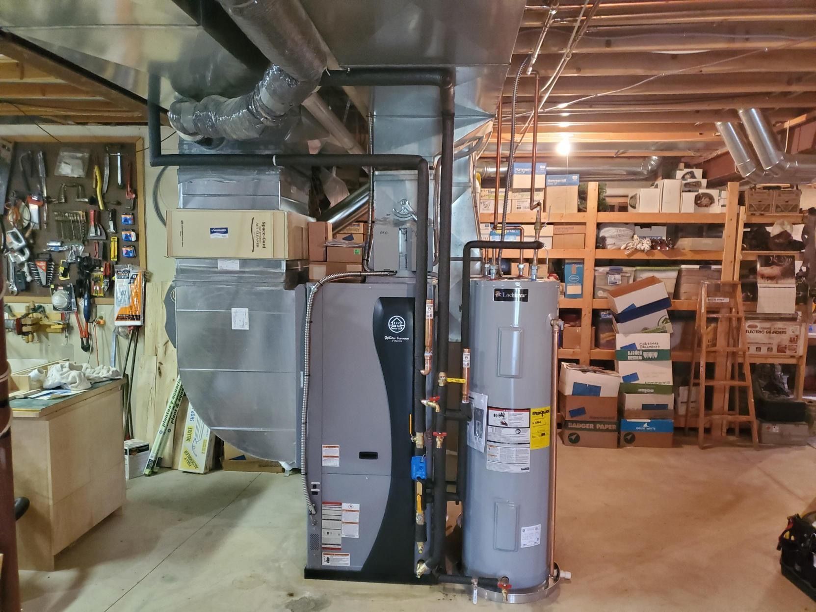 Geothermal heating system diagram: pipes buried underground extract heat to warm a house in a snowy landscape.