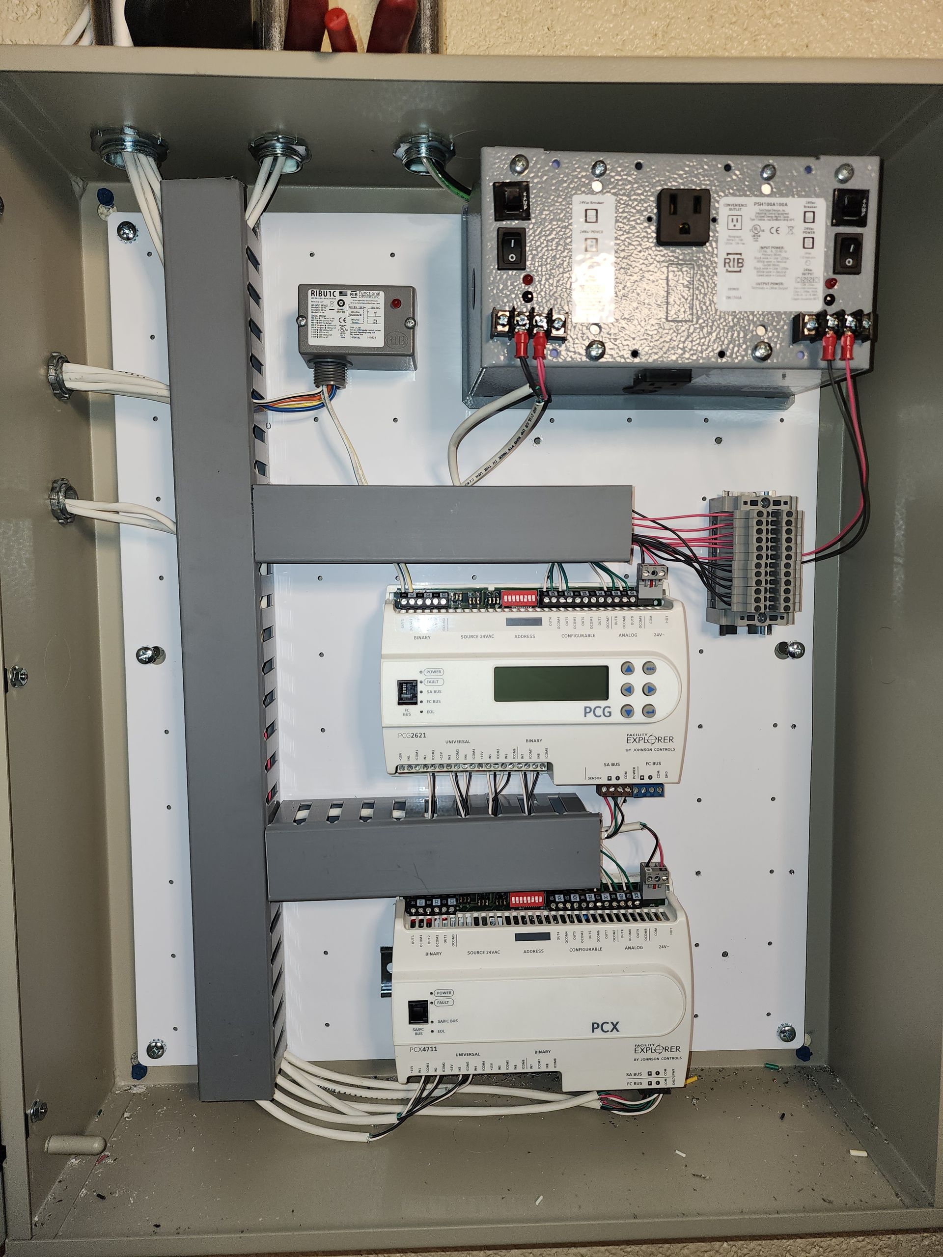 Electrical room with multiple gray panels, conduit, and boxes.