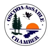 Oscoda-AuSable Chamber logo: Trees, sunset, geese in flight over water.