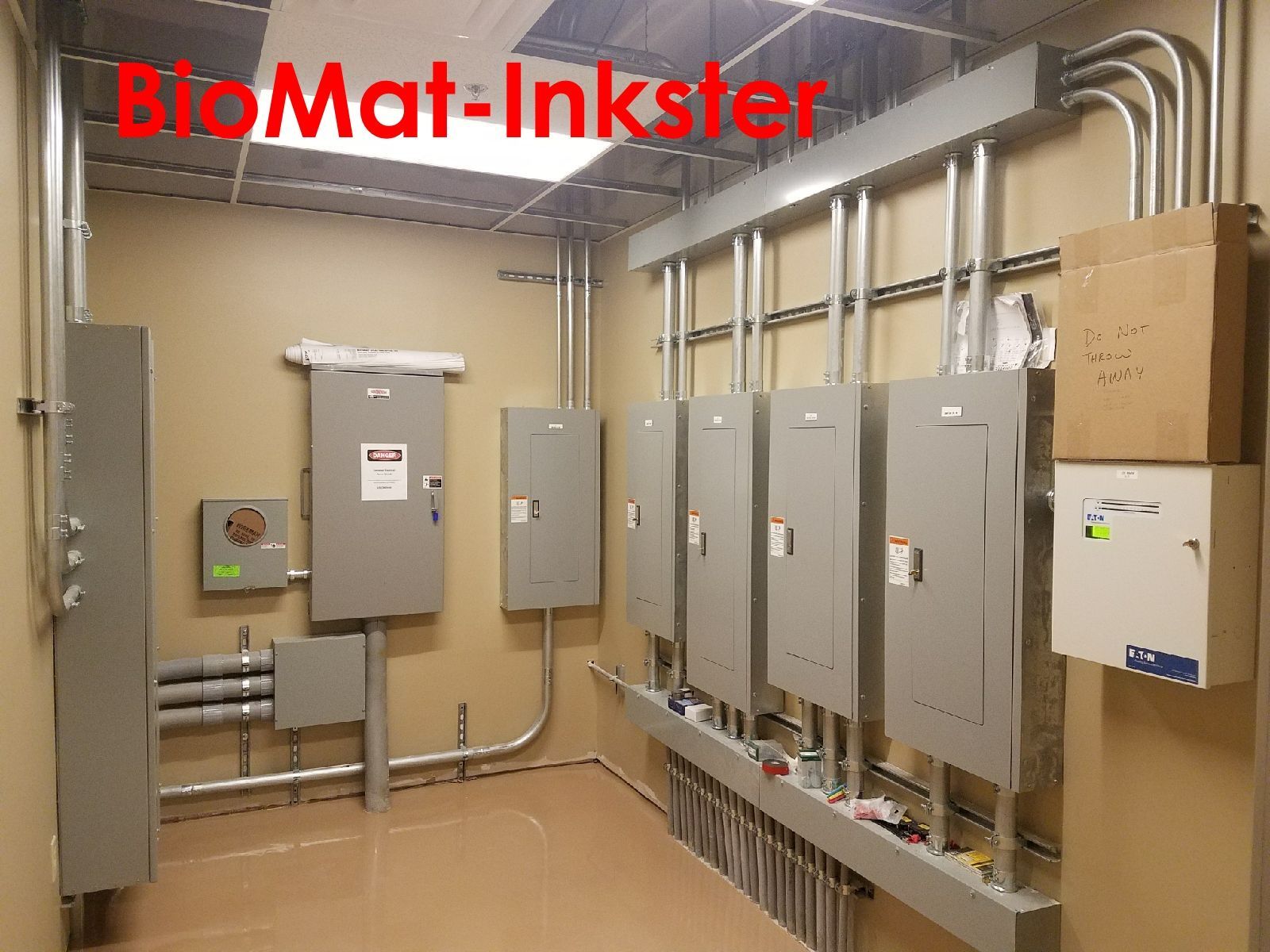 Electrical room with multiple gray panels, conduit, and boxes.