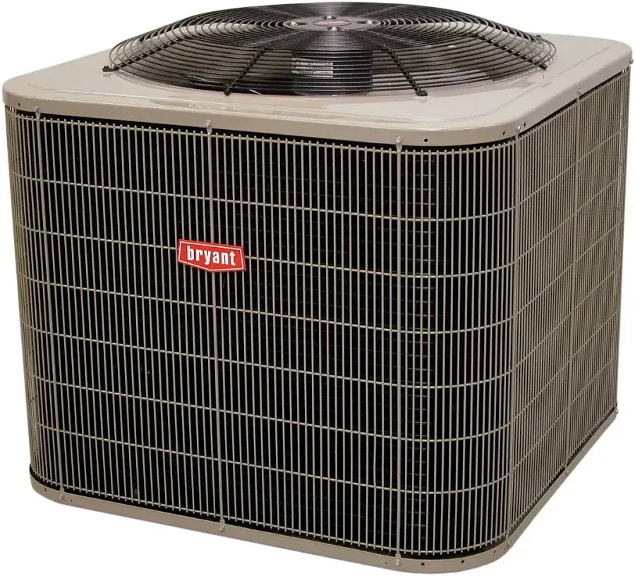 Bryant air conditioning unit outdoors with metal fan and grill.