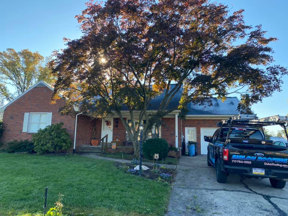 Shiloh Roofing Truck In Front Of A House — York, PA — Shiloh Roofing