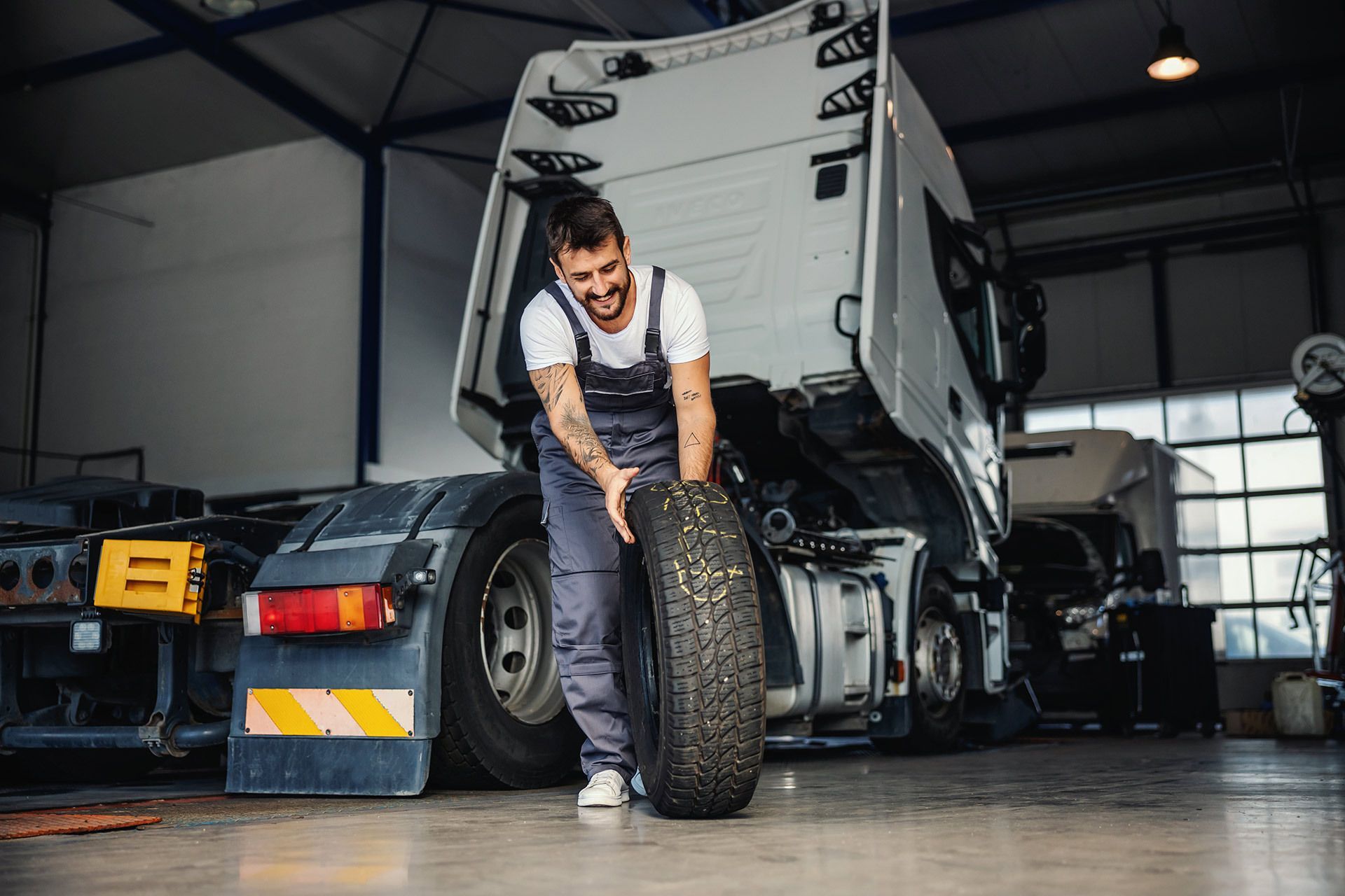 Man Holding A Big Tire