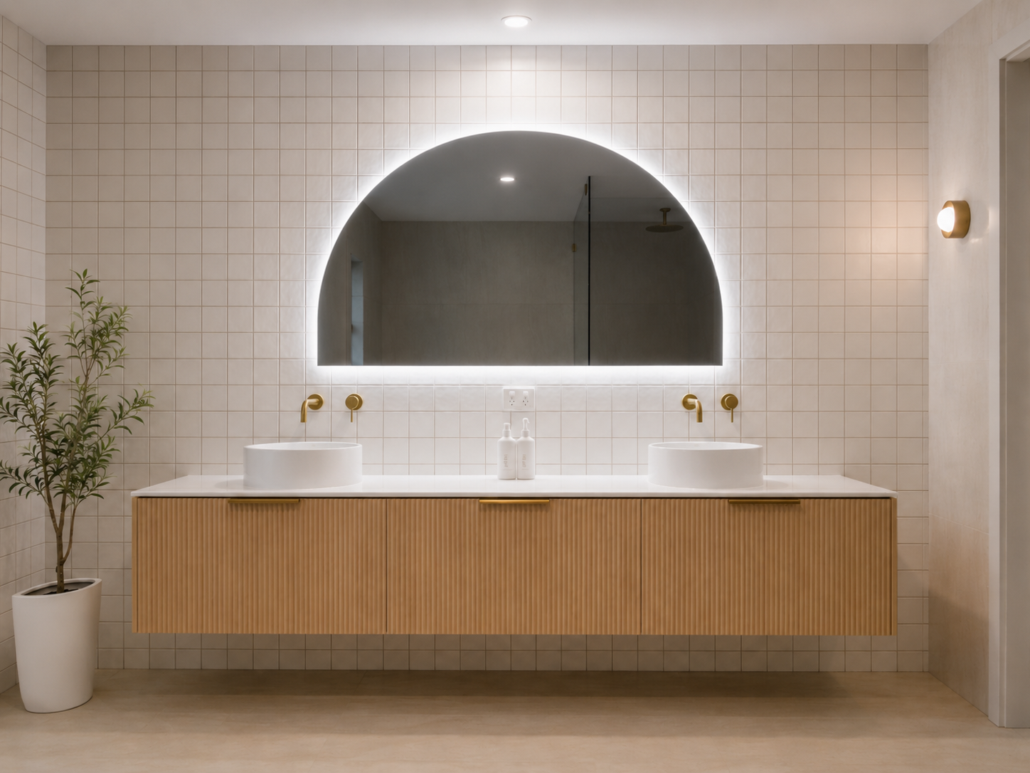 A bathroom with two sinks and a large mirror