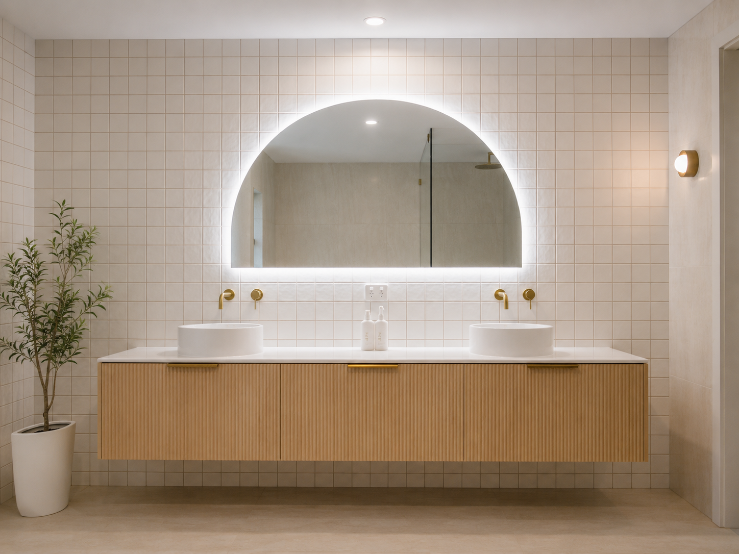 A bathroom with a sink , mirrors and a walk in shower.