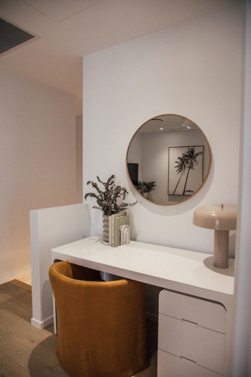 A bathroom with a bathtub , sink and mirror.