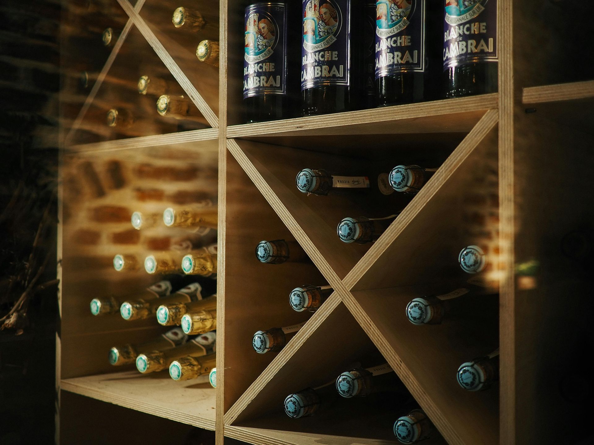 A wooden wine rack filled with bottles of wine