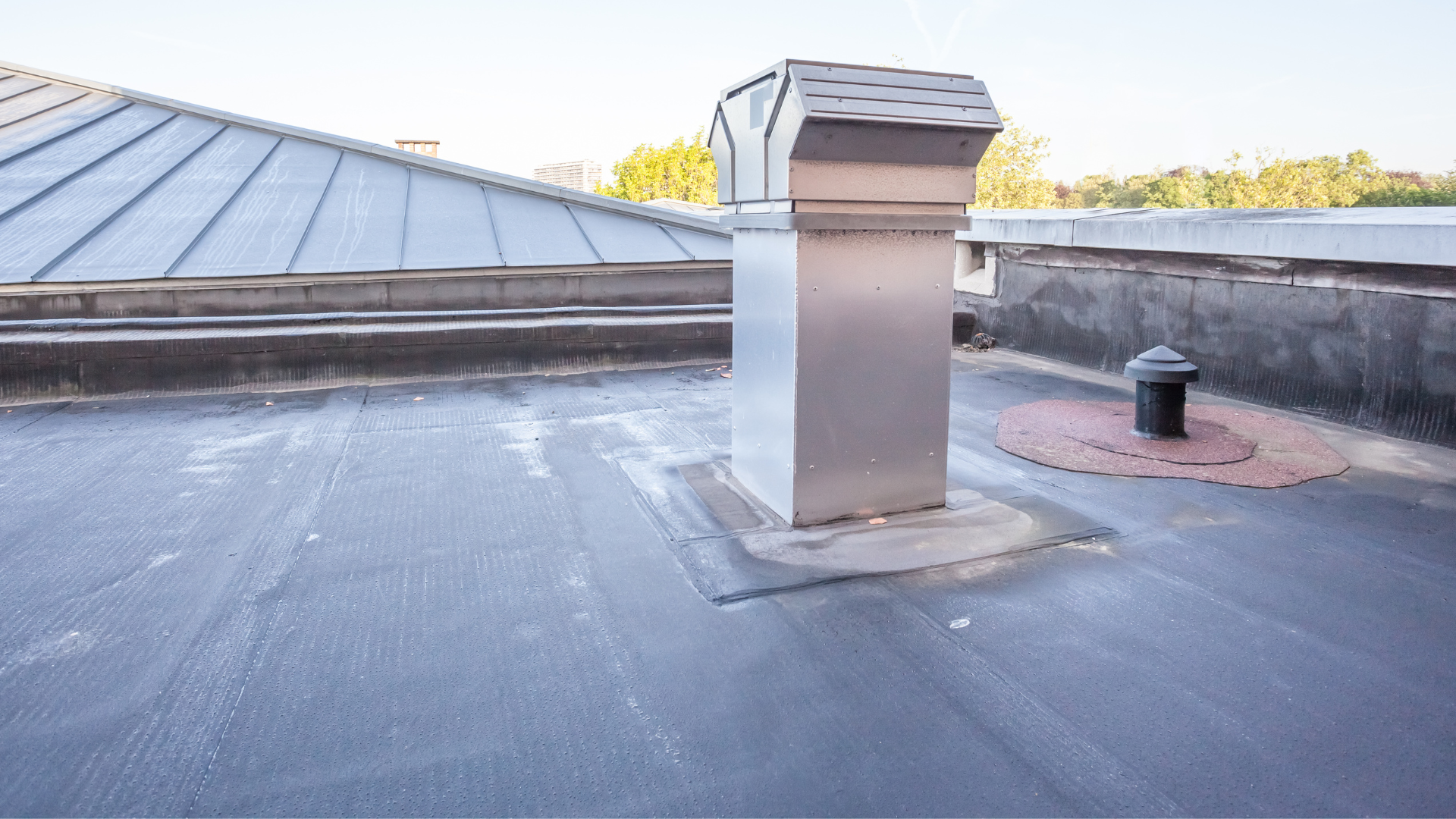 there is a chimney on the roof of a building .