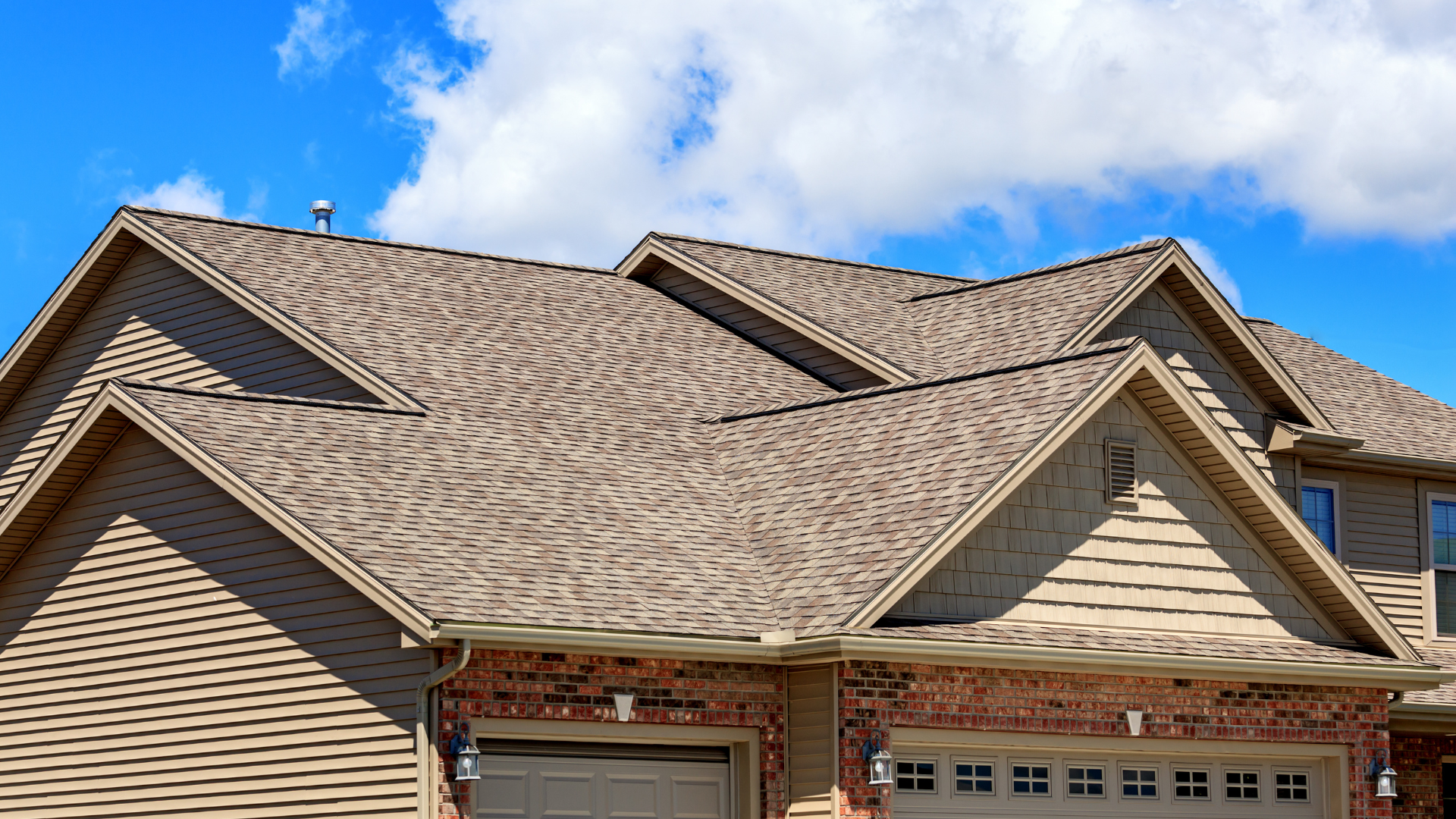 a large house with a large roof and a garage .