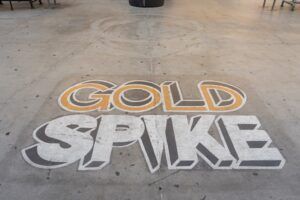 The word gold spike is painted on the floor