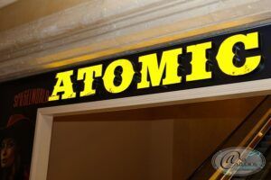 A black and yellow sign that says atomic on it