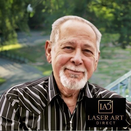 Man with white beard in striped shirt smiles, logo