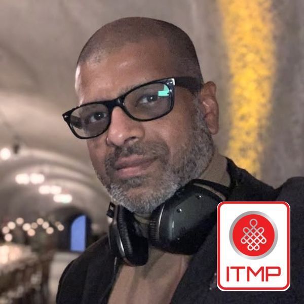 Man with glasses and headphones in a tunnel, with an ITMP logo in the corner