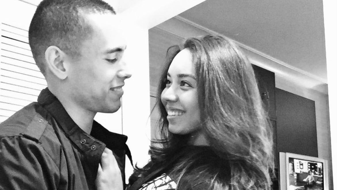 A man and a woman are looking at each other in a black and white photo.