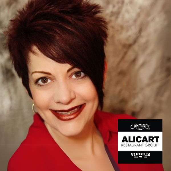 A woman is smiling in front of a sign that says alicart restaurant group