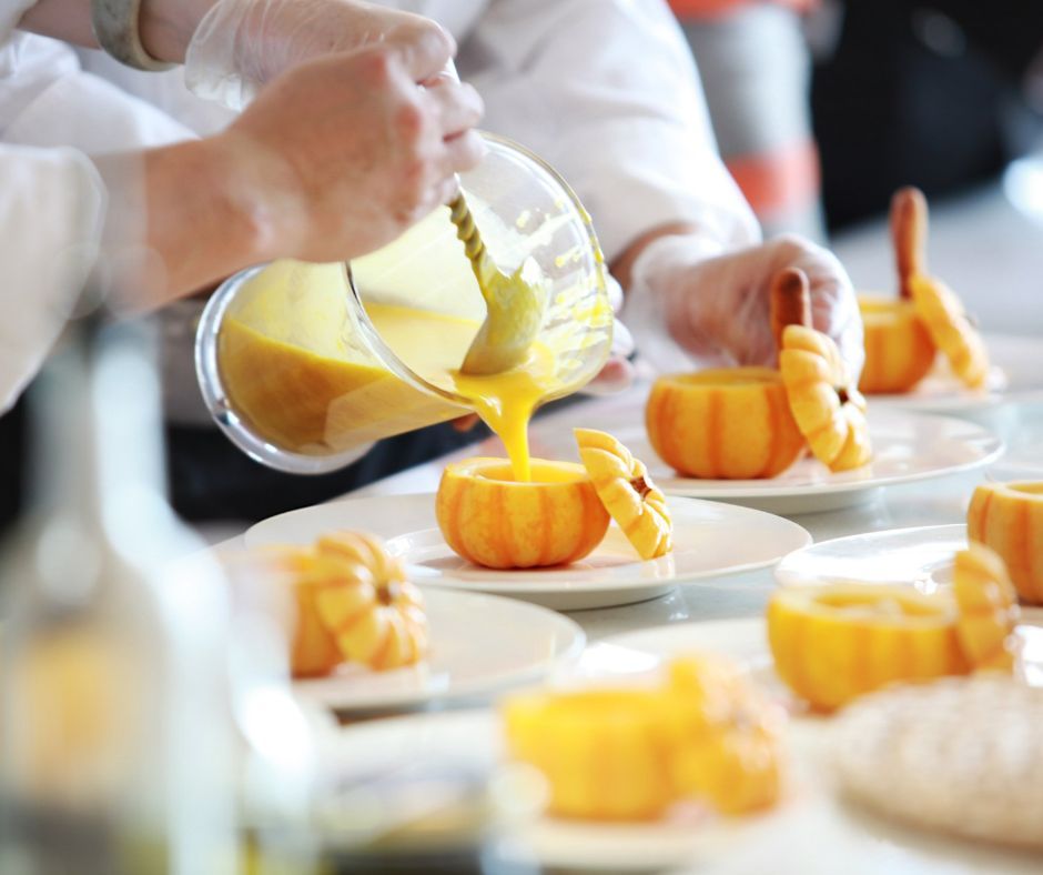 A group of people are preparing food in a kitchen.