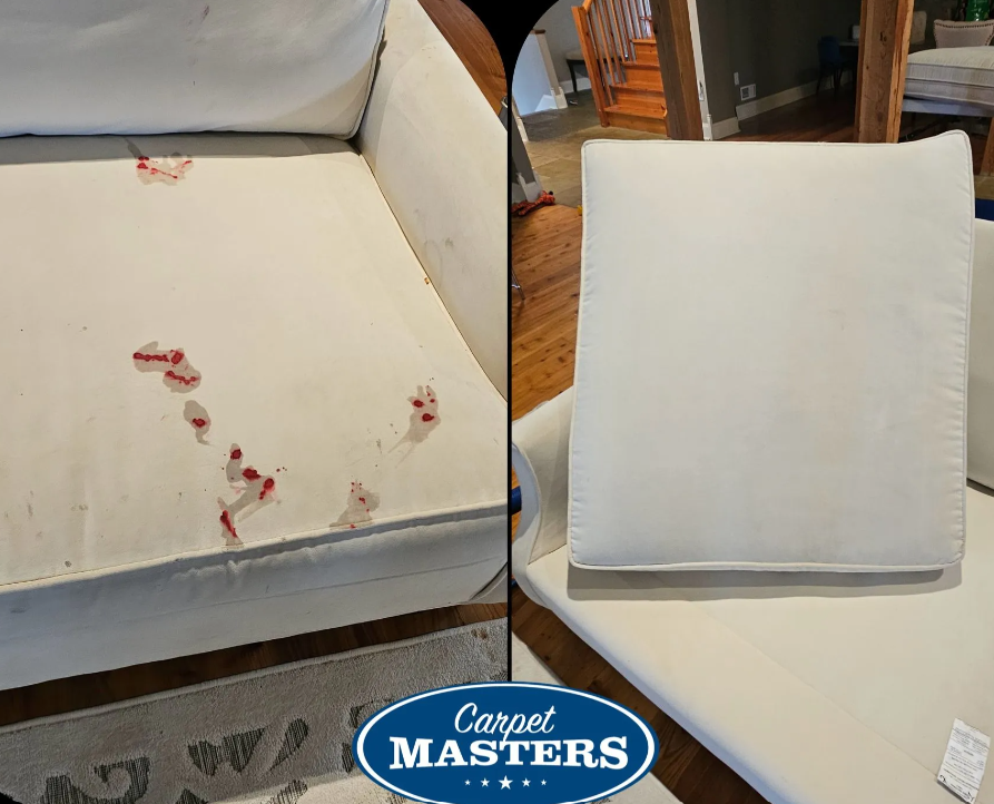 Beige upholstered couch with red stains on the left cushion; matching beige chair on the right.