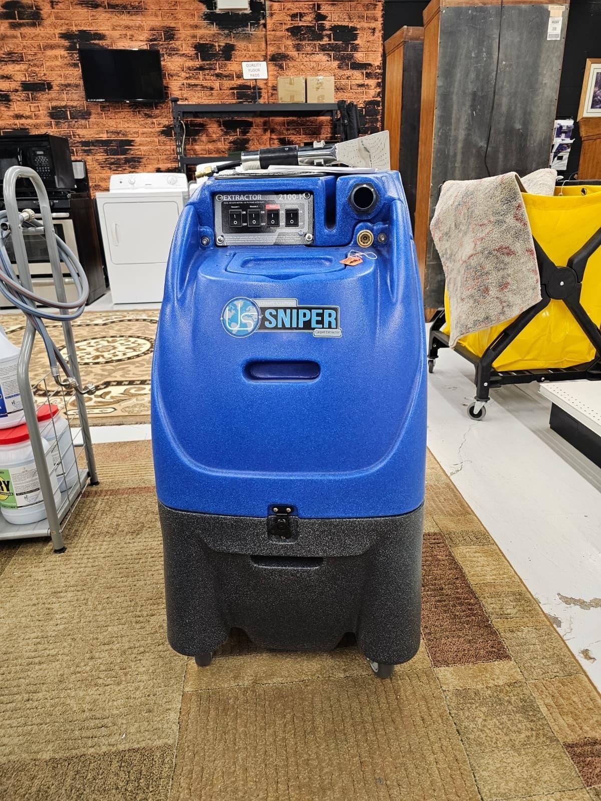 Blue industrial cleaning machine labeled “SNIPER” in a workshop setting.