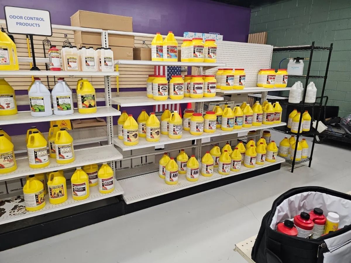 Store shelf stocked with yellow cleaning jugs and spray bottles in a retail aisle.