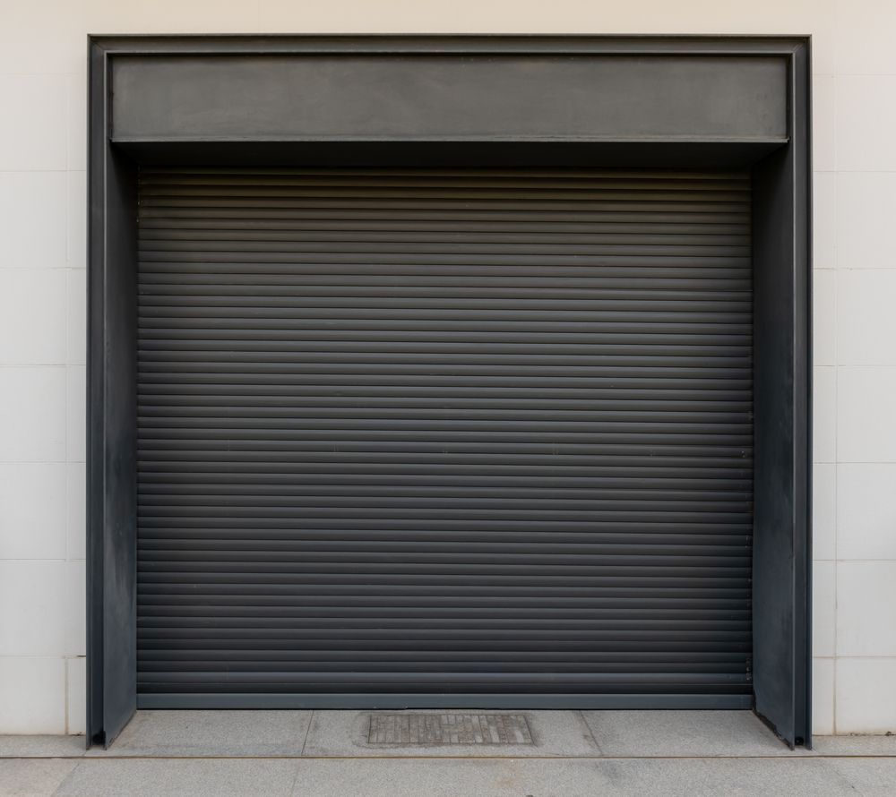Row of yellow loading dock doors at a warehouse with parked semi-trailer bays