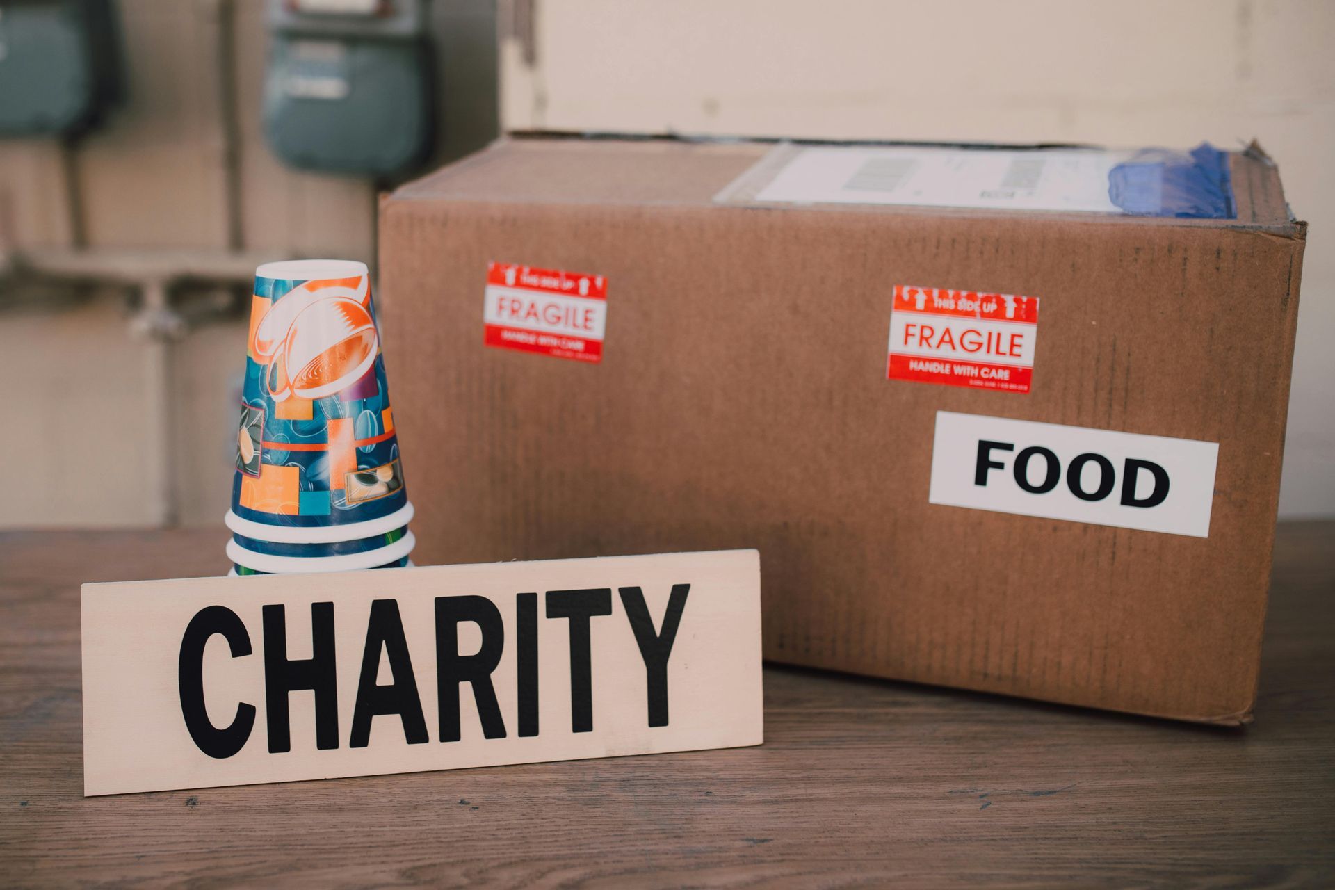 Charity food donation boxes with stacked canned goods on a table