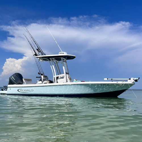 A white boat with a yamaha engine is in the water