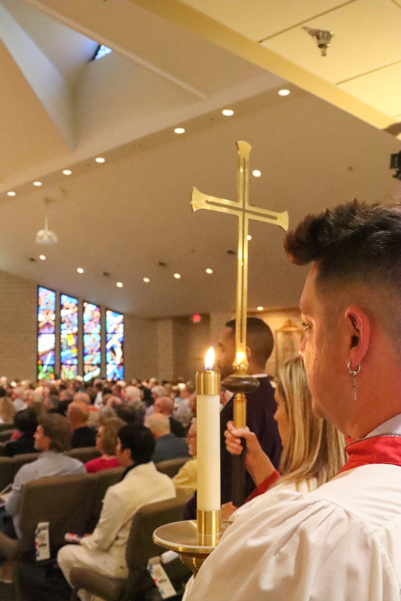 Photo of congregation with arms raised during worship service