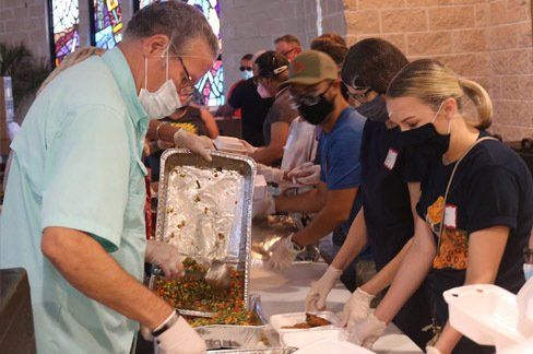 Volunteers making lunches for icare