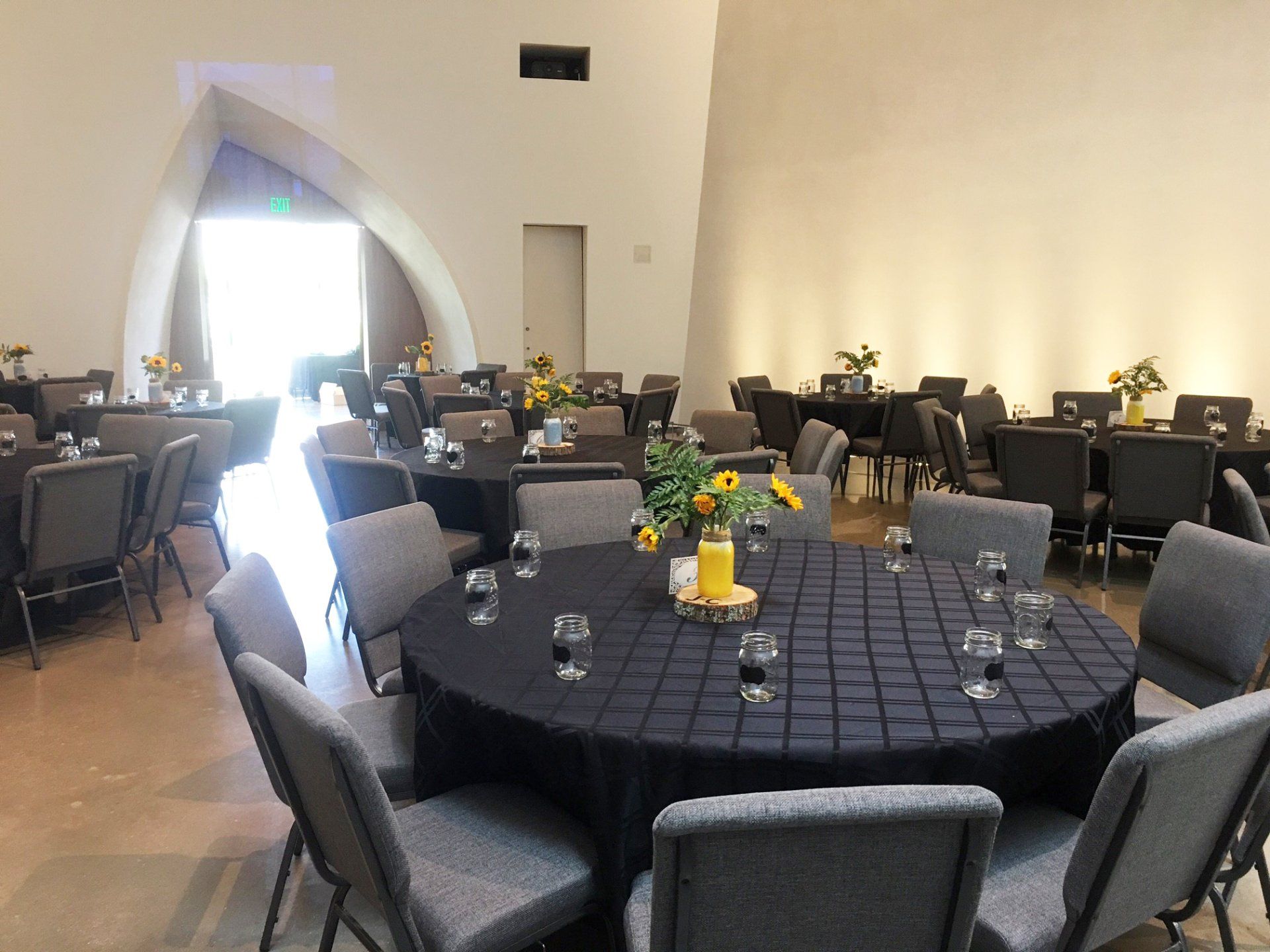 reception setup with large round tables and black tablecloths