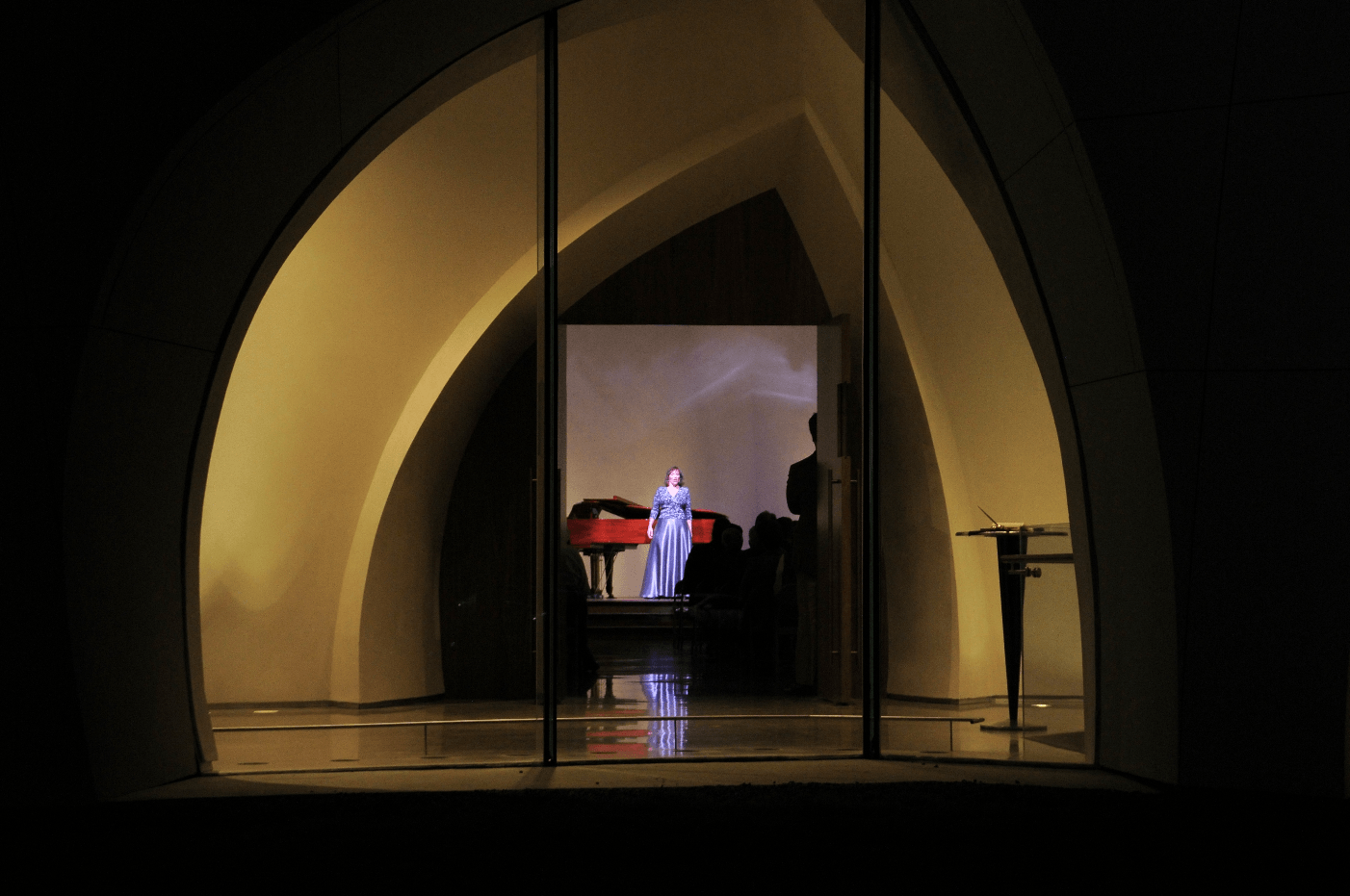 Interfaith Peace Chapel viewed through a window. Concert in progress.