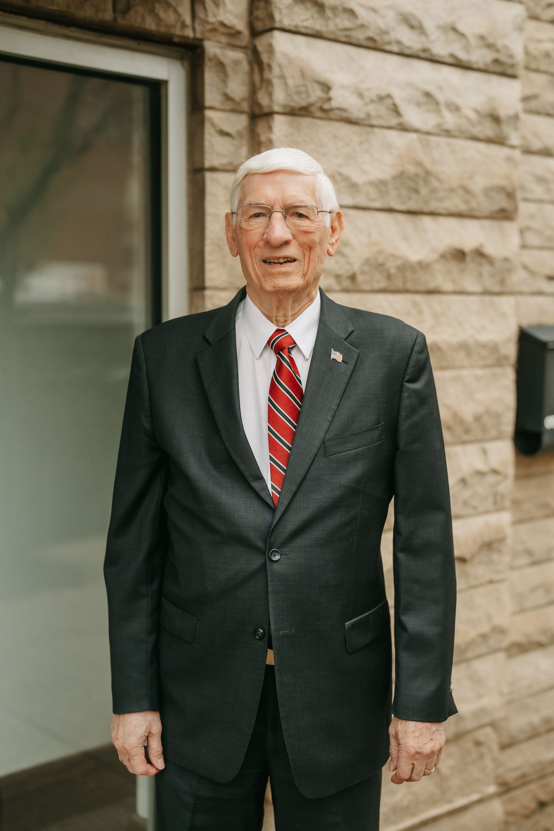 A man in a suit and tie is smiling for the camera.