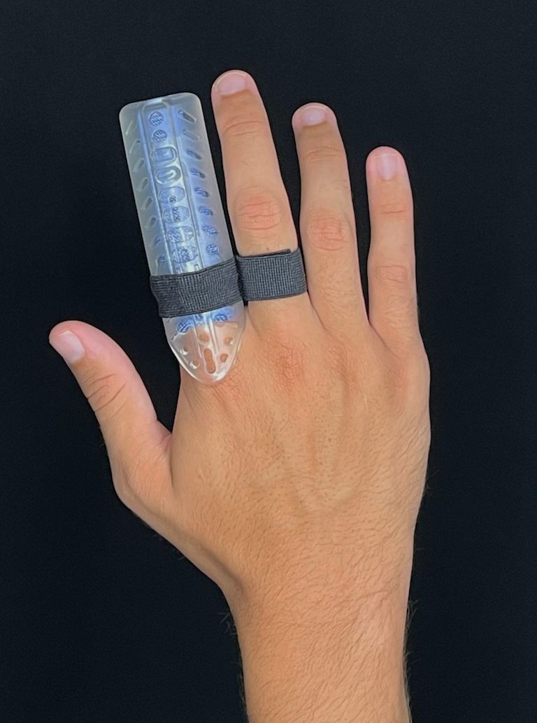 Hand with a DigiTube blue medical splint and black tape on two fingers against a black background