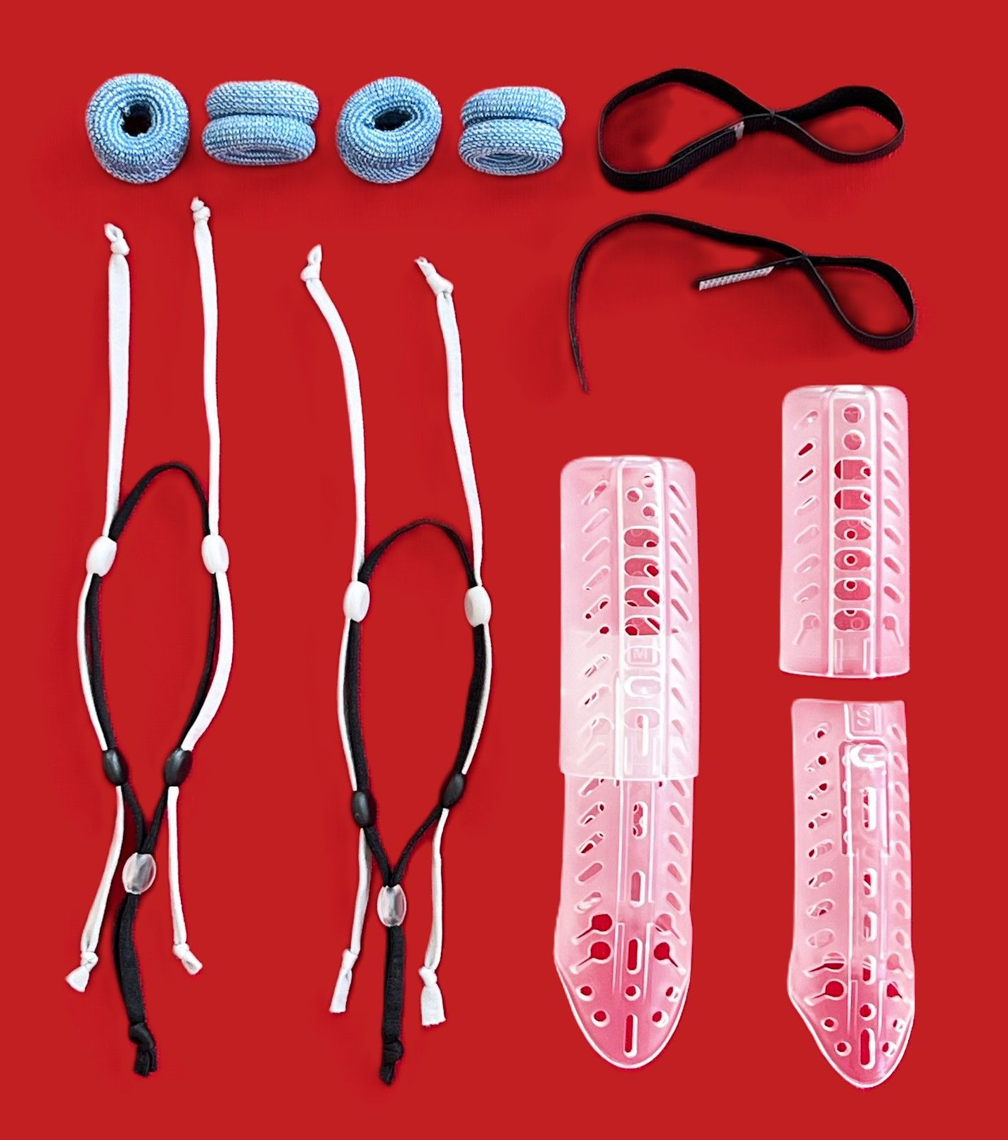 Assorted red and black bungee cords, blue clips, and pink plastic clip holders on a red background