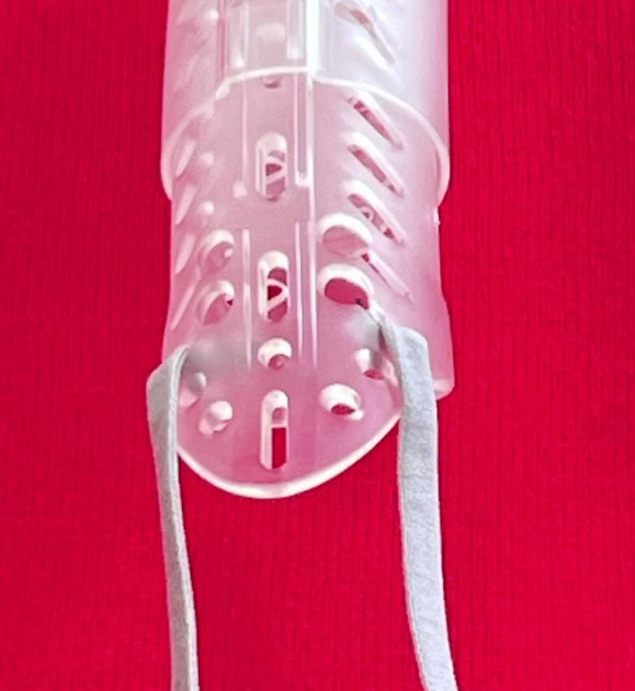 Transparent DigiTube splint against a bright red background