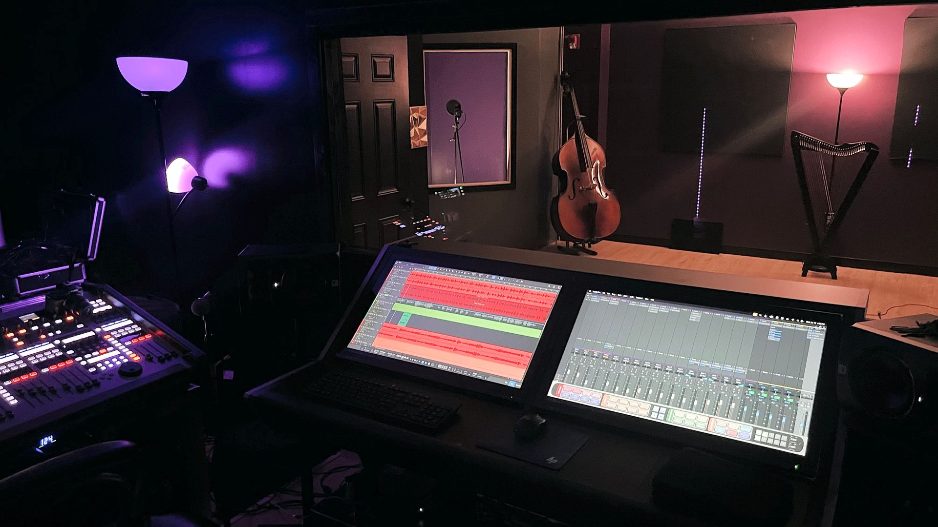 A recording studio with a cello in the background