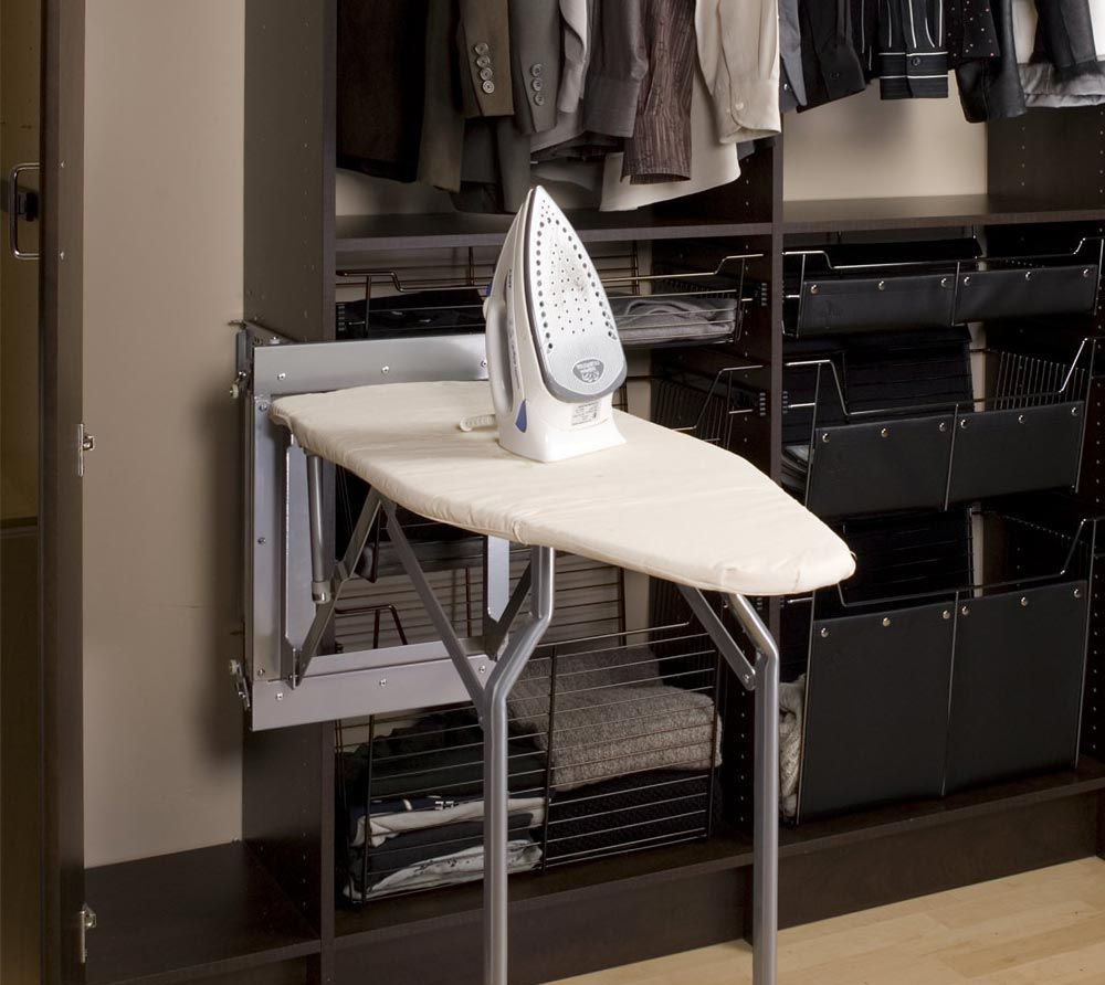 An ironing board with an iron on it in a closet