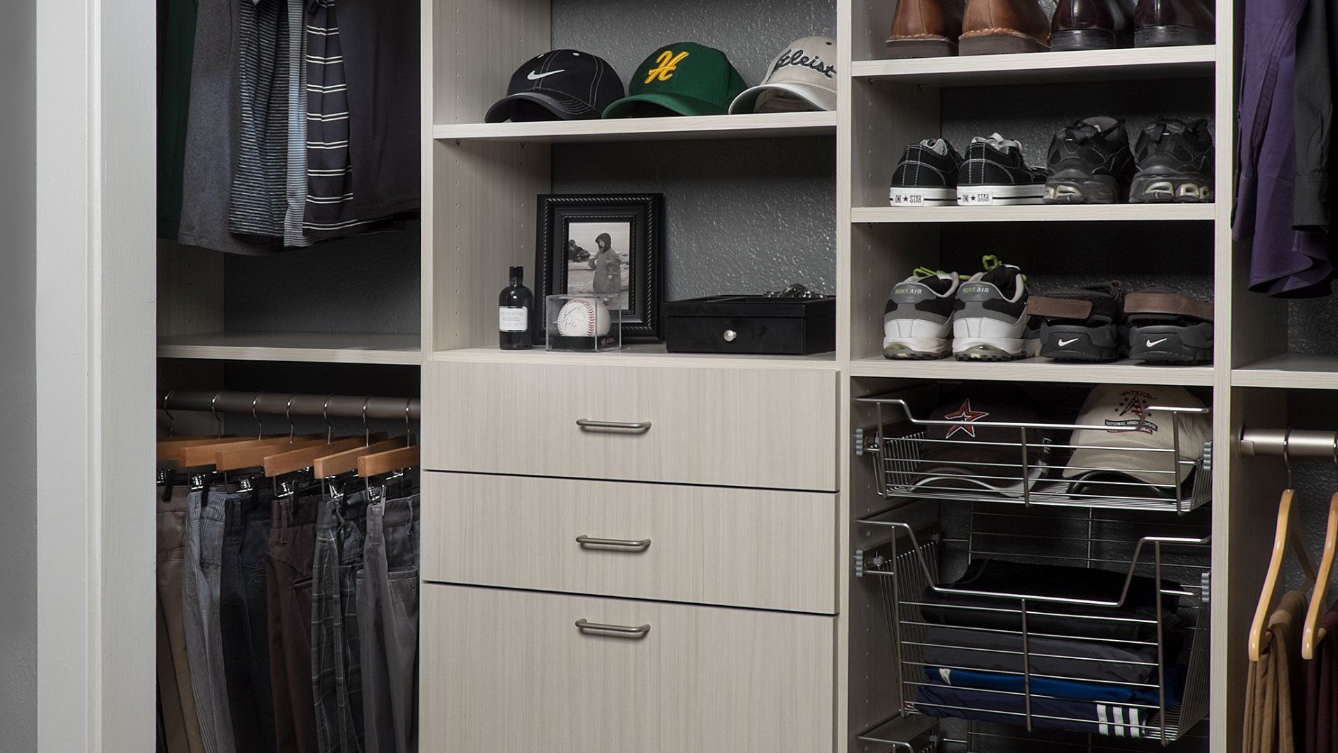 Organized closet with shelves, drawers, and hanging rods; hats, shoes, and clothing visible.