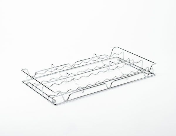 A chrome spice rack is sitting on a white surface.