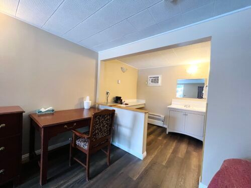 There is a desk and chair in the room.