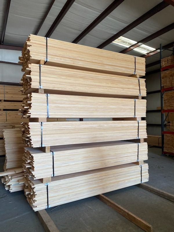A stack of wood is sitting in a warehouse.