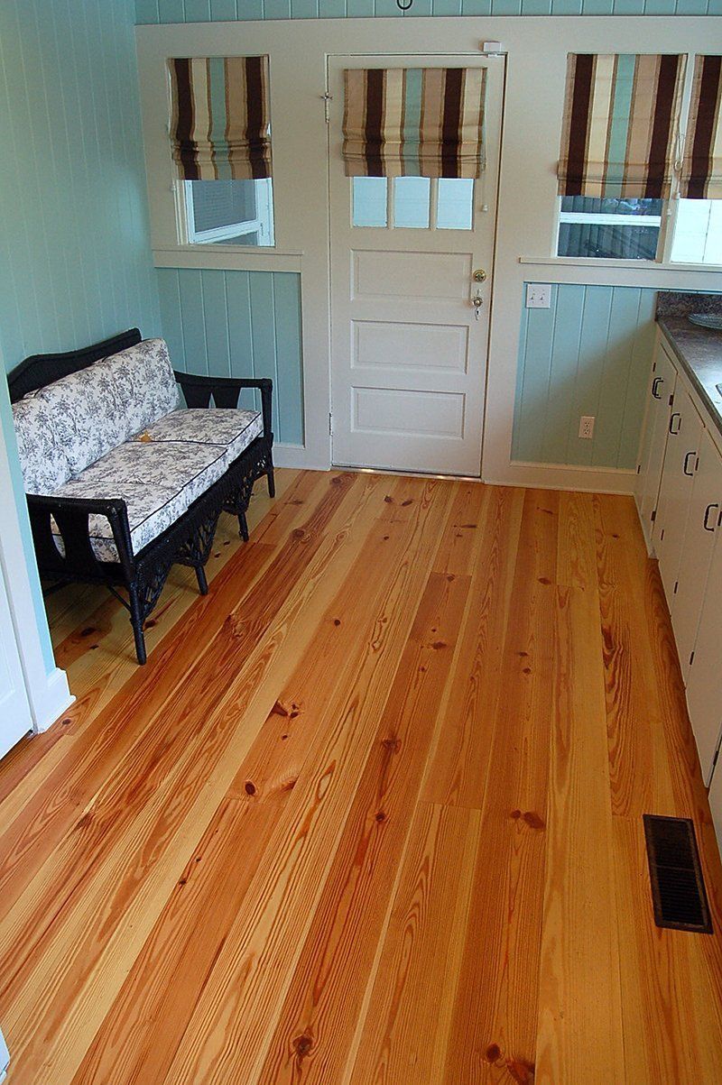A wooden floor in a room with a couch
