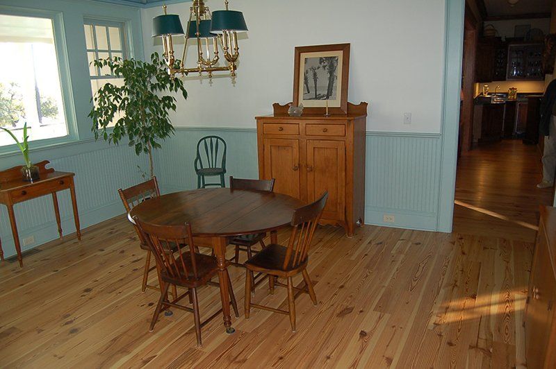 A dining room with a table and chairs and a chandelier.
